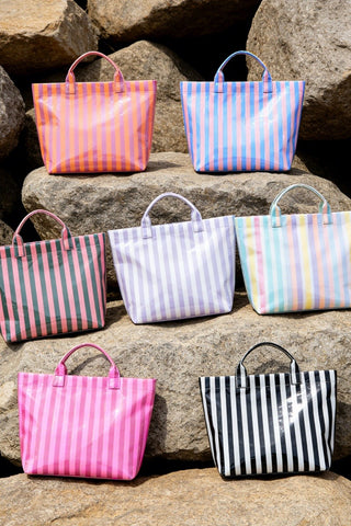 Your new go-to tote for beach days, pool trips, errands, and summer vacations! These glossy striped tote bags are lightweight, roomy, and come in the prettiest colorful combinations to match every summer vibe. Easy to wipe clean and perfect for tossing in all your sunny day essentials.

Comes in:

Pink & Green
Rainbow
Pink & Blue
Lavender & White
Fuchsia & Orange
Black & White
Hot Pink & Pink