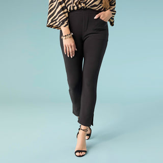 Polished, sleek, and effortlessly versatile — the Georgie Capri – Side Slit is a wardrobe essential that blends comfort with modern style. Designed with a flattering slim fit, these capri pants create a clean, streamlined silhouette that works perfectly for both casual and dressy occasions.

The subtle side slit at the hem adds a stylish touch while allowing for comfortable movement. With a smooth, structured look and classic black color, these capris pair beautifully with blouses, sweaters, or fitted tops 