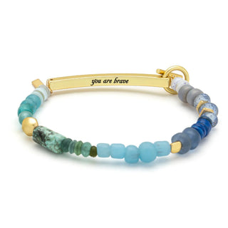 Like whiskey in a teacup, you are both beautiful and strong.&nbsp;Let this bracelet be your daily reminder of your inner power.&nbsp;Our latest collection has more than meets the eye. Each&nbsp;bracelet comes engraved with an empowering phrase of&nbsp;affirmation, from Classic to Edgy. Intentionally designed with&nbsp;energetic semi-precious stones, accented by gold and silver-dipped beads, every piece carries an inspirational meaning.