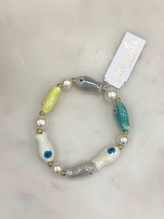 Playful pops of color meet meaningful design in this eye-catching stretch bracelet. Featuring glossy evil eye-inspired beads in soft coastal hues, paired with pearl accents and gold details, this bracelet brings both charm and positive energy to your everyday look. Easy to slip on and perfect for stacking or wearing solo.