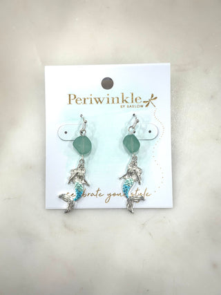 Channel coastal magic with the Sea Siren Charm Earrings. Featuring a delicate mermaid charm paired with a soft sea-glass inspired bead, these dangly earrings bring a whimsical, ocean-kissed vibe to any look. Lightweight with just the right movement, they’re perfect for beach days, summer nights, or adding a playful twist to everyday outfits.

Details

Dangly drop earrings

Mermaid charm with textured detailing

Sea-glass inspired bead accent

Lightweight and comfortable for all-day wear

