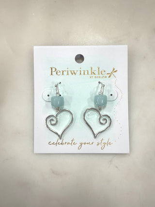 Soft coastal tones meet sweet, romantic charm in the Sea Glass Heart Drop Earrings. Featuring a smooth aqua bead paired with an open silver heart charm, these earrings offer gentle movement and a light, airy feel. Easy to wear and beautifully dangly, they add a touch of love-inspired elegance to everyday outfits.

Details
• Dangly drop earring design
• Open silver heart charm
• Soft aqua bead accent
• Silver-tone hardware
• Lightweight and comfortable
• Fish hook backing
