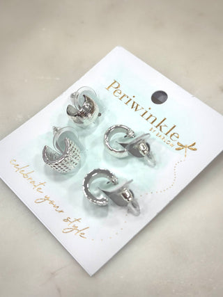 Elevate your everyday look with the Silver Texture Trio Hoop Set. This versatile set features three distinct pairs of silver-tone mini hoops, each with its own unique texture—from smooth shine to softly hammered and dotted finishes. Perfect for mixing, matching, or wearing solo, this set gives you endless styling options with effortless polish.

Details
• Set of 3 hoop earrings
• Silver-tone finish
• Mixed textures for versatile styling
• Mini hoop size
• Lightweight and comfortable
• Hinged closure

A must