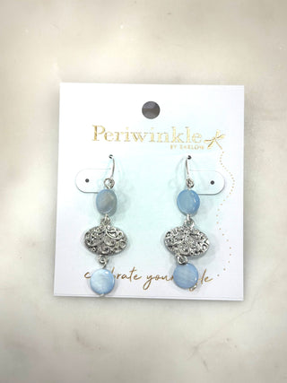Soft sky-blue tones meet vintage-inspired detail in the Blue Harbor Charm Drop Earrings. Featuring smooth blue beads paired with an ornate silver charm, these earrings add gentle movement and timeless elegance to any outfit.

Details
• Silver-tone hardware
• Light blue bead accents
• Ornate charm centerpiece
• Lightweight dangle style
• Hook closure

An easy, everyday accessory that brings a calm, coastal touch with just the right amount of detail.

Final Sale
✨ All accessories are FINAL SALE.