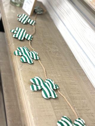 Add a festive touch of luck to your space with our Shamrock Strip Garland! Featuring layered fabric strips in classic greens with playful shamrock accents, this garland brings texture, movement, and seasonal charm to any room. Drape it across a mantel, shelf, entryway, or table for an easy St. Patrick’s Day refresh.

Lightweight and flexible, it’s simple to style and reuse year after year—perfect for cozy homes, boutiques, or party décor. (Green and White stripes)

Details:

Shamrock-themed design

