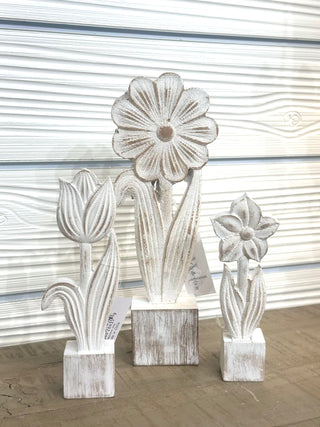 Add a fresh, airy touch to your home with these Distressed Spring Flower Wood Decor pieces. Featuring beautifully carved floral designs and a soft whitewashed finish, each piece brings subtle texture and charm to shelves, mantels, and tabletops. Style them together for a layered look or place individually throughout your space for effortless spring and summer styling.

✨ Sold individually — each flower is priced separately.

STYLE OPTIONS &amp; SIZES:

Daisy – approx. 11 inches tall
