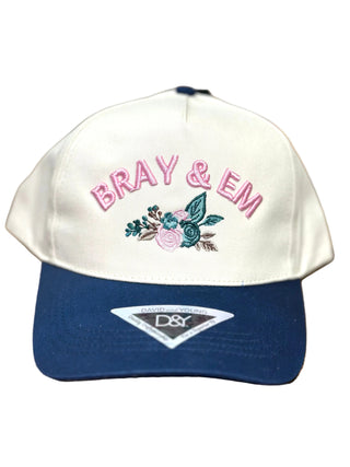 Show off your Bray &amp; Em pride in style with our Bray &amp; Em Floral Embroidered Trucker Hat. Featuring beautifully embroidered pink lettering with a delicate floral design, this hat combines everyday comfort with a feminine touch you'll love.

Designed with a structured front, curved brim, and breathable mesh back, it's the perfect accessory for busy days, casual outings, ball games, or throwing on with your favorite boutique outfit.

