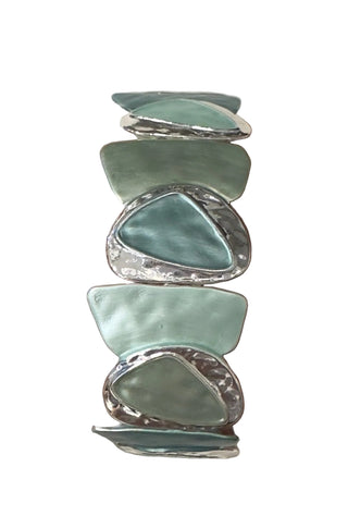 Designed with bold coastal elegance, the Sea Glass Statement Stretch Bracelet features oversized, sea glass–inspired stones framed with textured silver accents. The soft aqua and mint tones create a calming, ocean-inspired palette that instantly elevates any look.

Comfortable and easy to wear, the stretch design allows for a flexible fit while delivering standout style. Perfect for making a statement on its own or pairing with simpler pieces for balance.