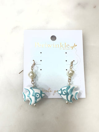 Inspired by seaside charm, the Coastal Catch Drop Earrings feature a hand-painted fish design accented with soft pearl-like beads. The lightweight drop silhouette adds movement while the ocean-inspired colors bring a fresh, playful touch to any outfit.

Perfect for beach days, summer outings, or adding a little coastal personality to everyday looks.