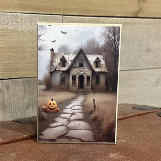 Welcome the magic of Halloween into your home with The Pumpkin Watches, a beautifully handcrafted 4x6-inch freestanding wood block inspired by vintage autumn nights and classic haunted tales. Featuring a weathered Victorian farmhouse beneath a glowing moon, this enchanting design showcases a carved jack-o'-lantern quietly standing guard along a winding stone path, as if protecting the season's best-kept secrets.

