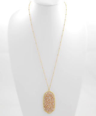 Soft, elegant, and effortlessly wearable, the Bead Glass Hexagon Pendant Necklace adds a subtle touch of shine to any look. Featuring a glass hexagon pendant accented with delicate beads, this piece brings just the right balance of modern shape and feminine detail.

Designed with a longer length, it’s perfect for layering or wearing solo to elevate everyday outfits with ease.

DETAILS:

Glass hexagon pendant design

Beaded accent detail

Available in Ivory or Champagne

Lobster clasp closure

Length: 32”

