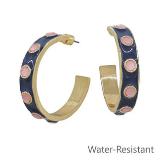 Add a playful pop of color to your jewelry collection with the Navy Blush Hoop Earrings. These bold hoops feature a rich navy enamel finish accented with soft blush cabochon details and a polished gold-tone trim for the perfect blend of modern and classic style. Lightweight yet eye-catching, they're an easy way to elevate everything from your favorite denim to a little black dress.


