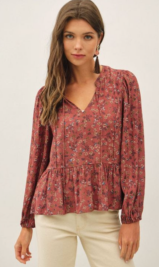 Soft, feminine, and effortlessly flattering, the Autumn Meadow Floral Peplum Top is the perfect piece for transitioning through the seasons. Featuring a warm almond floral print, a split neckline with delicate tie detail, long sleeves with elastic cuffs, and a flowy peplum silhouette, this blouse pairs beautifully with your favorite denim and booties for an easy everyday look.

Almond floral print
Split neckline with adjustable tie detail
Long sleeves with elastic cuffs
Flattering peplum silhouette