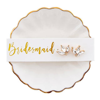 A meaningful little gift for the ones standing by your side. This bridesmaid trinket tray and earrings set is the perfect way to say thank you, pairing a delicate ceramic dish with coordinating earrings she can wear on the big day and beyond. Perfect for holding rings, jewelry, or small keepsakes, it’s a sweet reminder of your special day together.

Details:
• Includes trinket tray + matching earrings
• Material: Ceramic + Zinc Alloy
• Size: 3" diameter