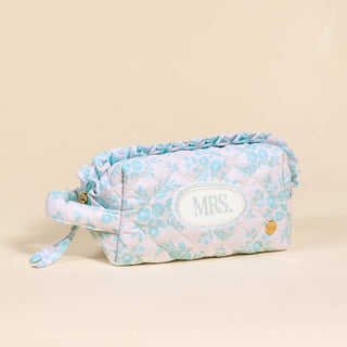 Keep your essentials perfectly organized with this charming quilted cosmetic pouch from our Say I Do: Bridal Collection. Featuring the delicate Something Blue pattern, this piece blends soft texture with everyday function—perfect for your makeup, travel must-haves, or bridal day essentials.

Details:

Perfect size for daily essentials
Soft quilted fabric
Small handle for easy carrying or hanging
Gold zipper hardware for a polished touch
Wipeable interior lining for easy cleaning
Dimensions: 7.5” x 3.5” x 5”
