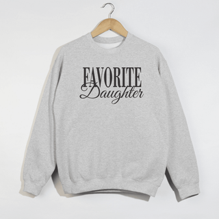 Because every family has a favorite 😉 This ash grey “Favorite Daughter” sweatshirt is the effortless, throw-on-and-go piece you’ll keep reaching for. Featuring a relaxed fit and a timeless script graphic, it’s equal parts comfy, confident, and just a little cheeky. Perfect for coffee runs, lounging at home, or pairing with leggings and sneakers for an easy everyday look.

Details:
• Ash grey color with “Favorite Daughter” script
• Unisex, relaxed fit
• Cozy fleece interior
• Classic crewneck sweatshirt
