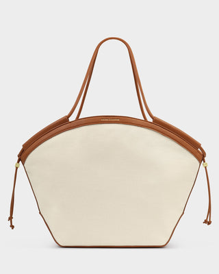 Inspired by sun-soaked escapes and effortless style, the Coastal Carryall Canvas Tote blends durable canvas with smooth vegan leather trim for a timeless, elevated look. Designed for both style and function, this spacious tote is perfect for everyday outings, travel days, or beachside getaways.

Featuring gold-tone hardware, a secure magnetic closure, and an internal zip pocket to keep essentials organized, this bag offers the perfect balance of practicality and polished style. 