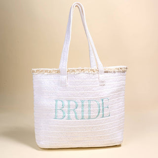 Thoughtfully created to pair beautifully with our Say I Do: Bridal Collection, this roomy tote captures the effortless charm of beach days and tropical getaways. Designed with an airy, lightweight feel, it offers plenty of space for all your warm-weather essentials—from towels and snacks to your everyday must-haves. The natural texture and sunny vibe make it a go-to accessory for pool days, picnics, and weekend adventures.

Details:

Lightweight paper straw design
Spacious interior for beach or everyday