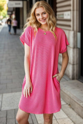 Cute, casual, and effortlessly comfortable — the Urban Girl Ribbed Mini Dress is the perfect everyday piece for your wardrobe. Featuring a soft ribbed texture and a relaxed silhouette, this dress offers an easy throw-on style that still looks put together.

Designed with short sleeves and a classic crew neckline, it provides a flattering and comfortable fit while the side pockets add a practical touch. Whether you're running errands, meeting friends, or enjoying a casual day out.